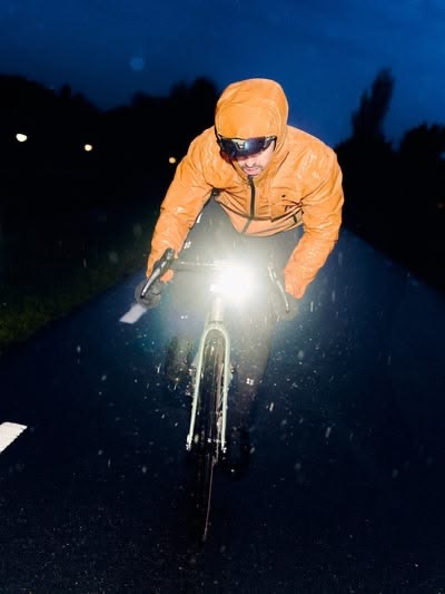 ALPH rider climbing in the rain, high-visibility jacket, night conditions