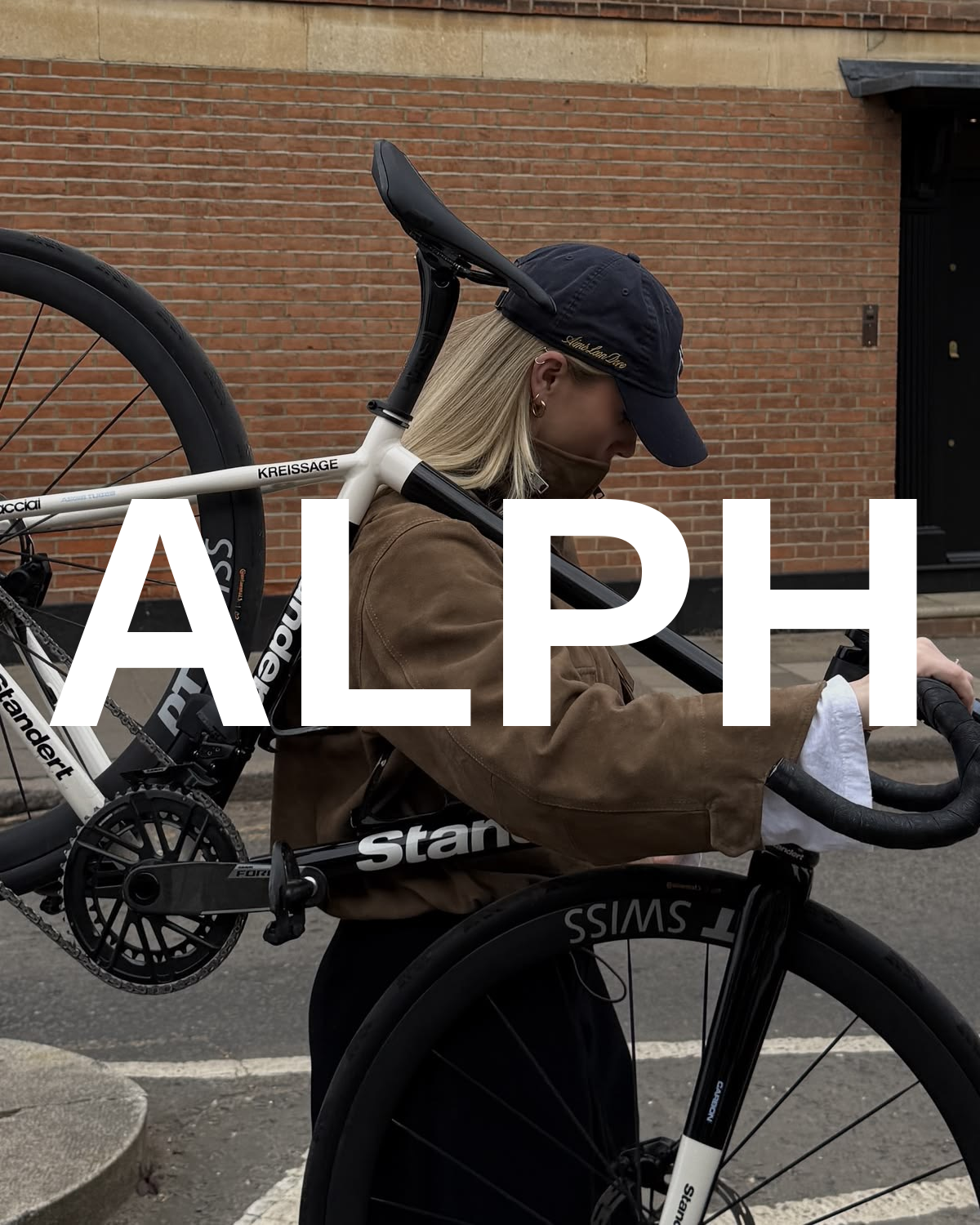 ALPH wordmark over a rider carrying a bike across the shoulder